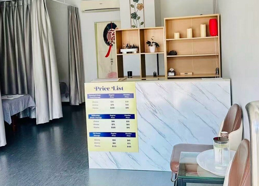Rosedale Traditional Massage reception in Auckland, NZ featuring a calming entrance and service price list.