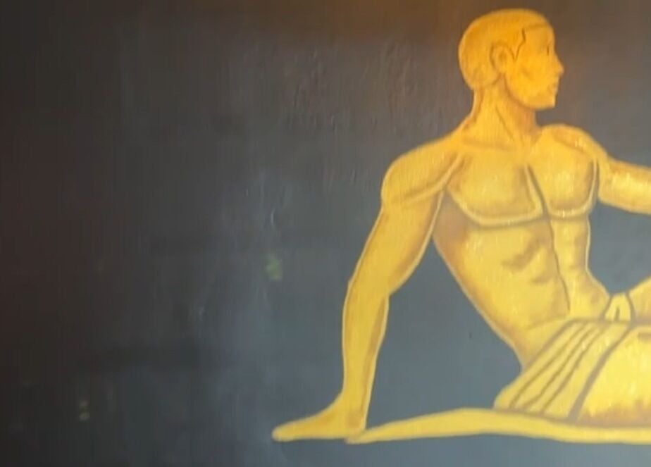 Golden figure mural at Velour Men’s Spa, Atlanta, Georgia, US, enhancing the serene ambiance.