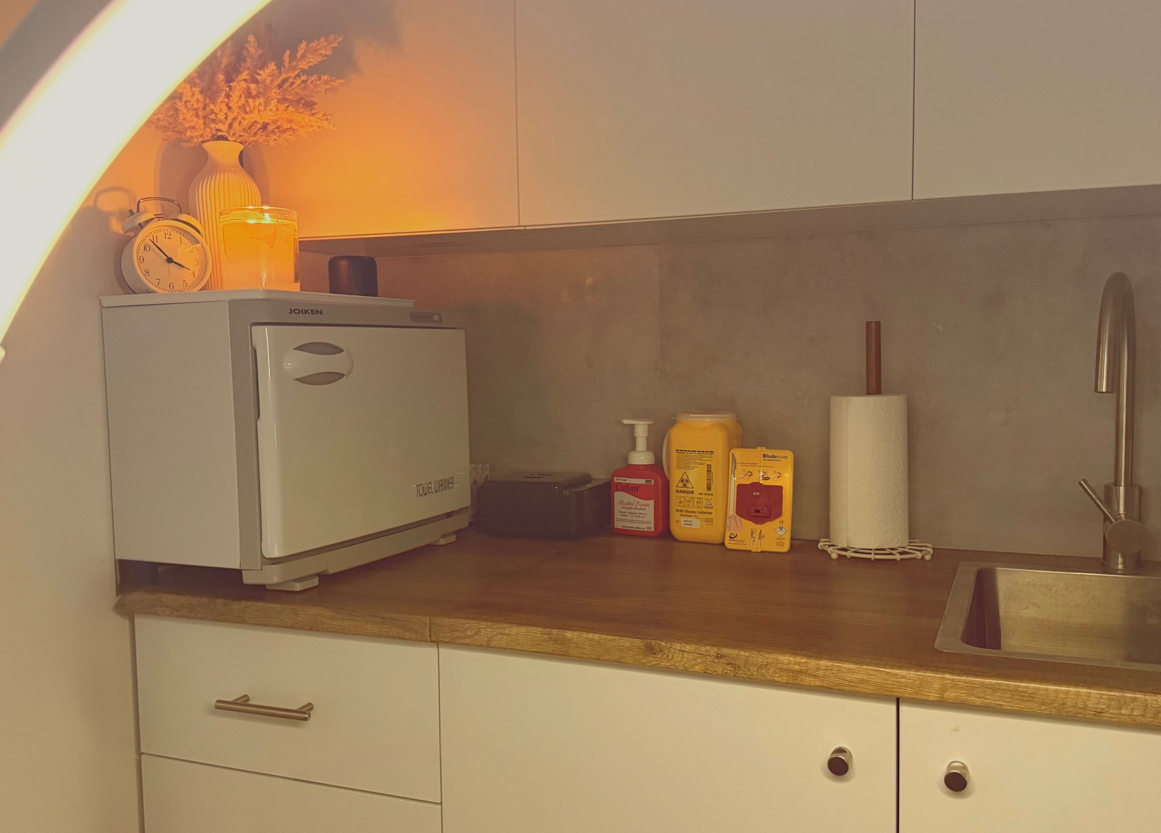 Cozy countertop at M.N.M Beauty Bar, Roselands, NSW with warm lighting and sink.