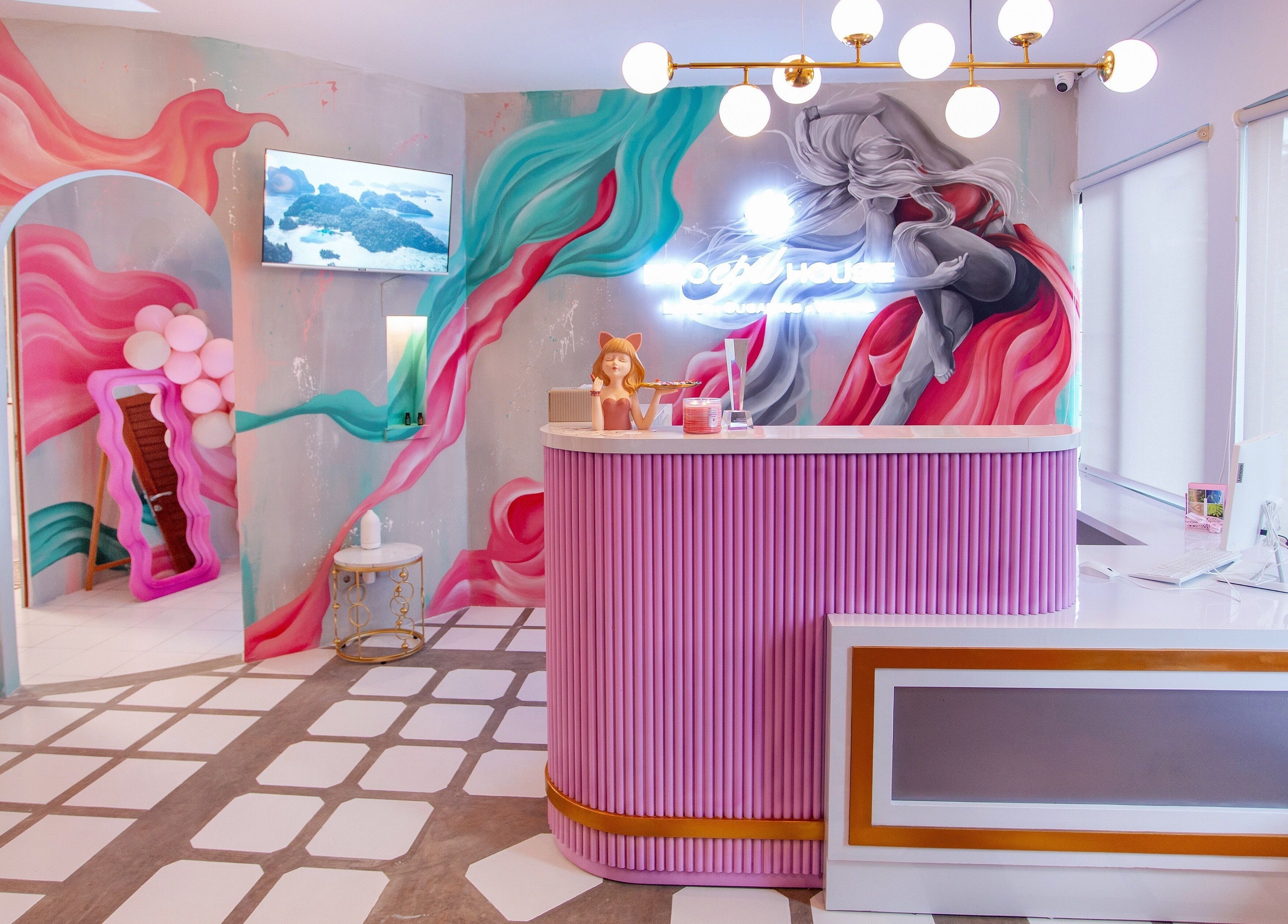 Bright reception area at Pro Epil House Ubud, Bali with artistic walls and colorful decor.