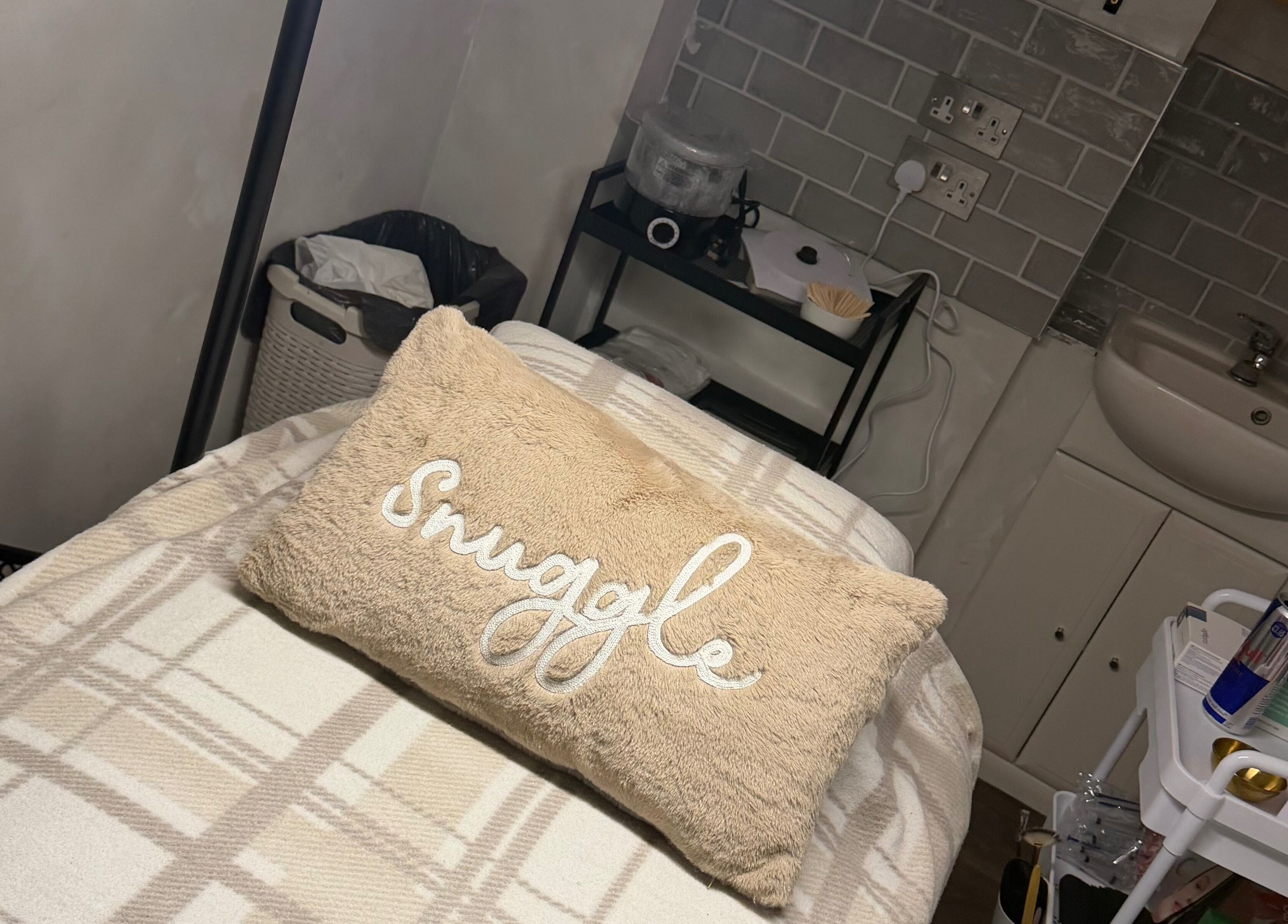 Relaxing treatment room at TL SkinStudio, Devizes, England, GB, featuring a cozy pillow on a massage table.