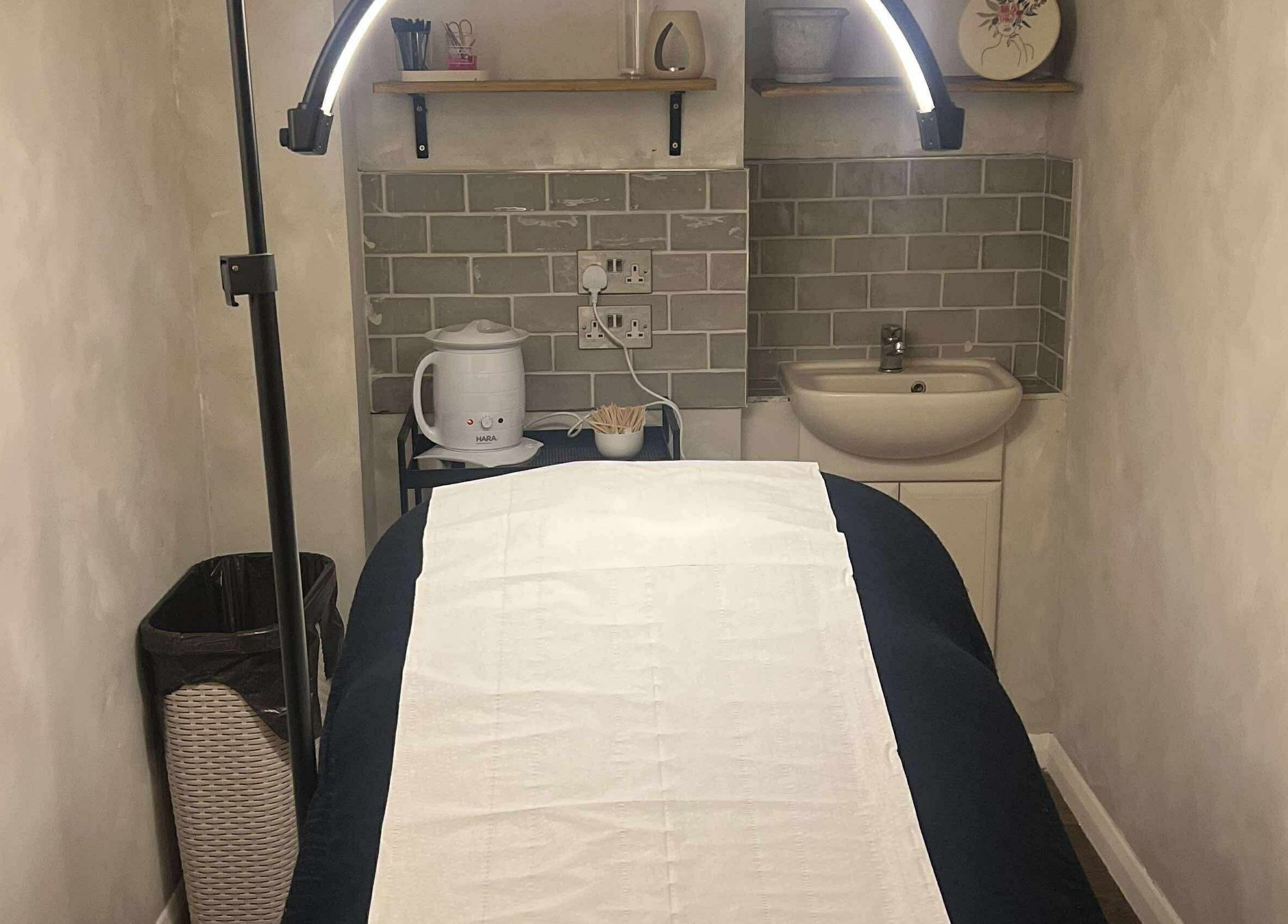 Serene treatment room at TL SkinStudio, Devizes, England, GB with ambient lighting and a comfortable spa bed.