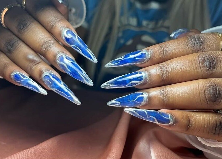 Stunning blue nail art at Coco’s Nails, Centurion, Gauteng, ZA; featuring intricate designs and glossy finish.