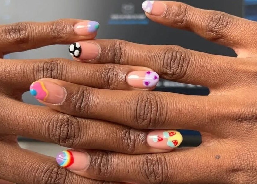Colorful nail art at Coco’s Nails, Centurion, Gauteng, ZA, showcasing unique designs on manicured hands.