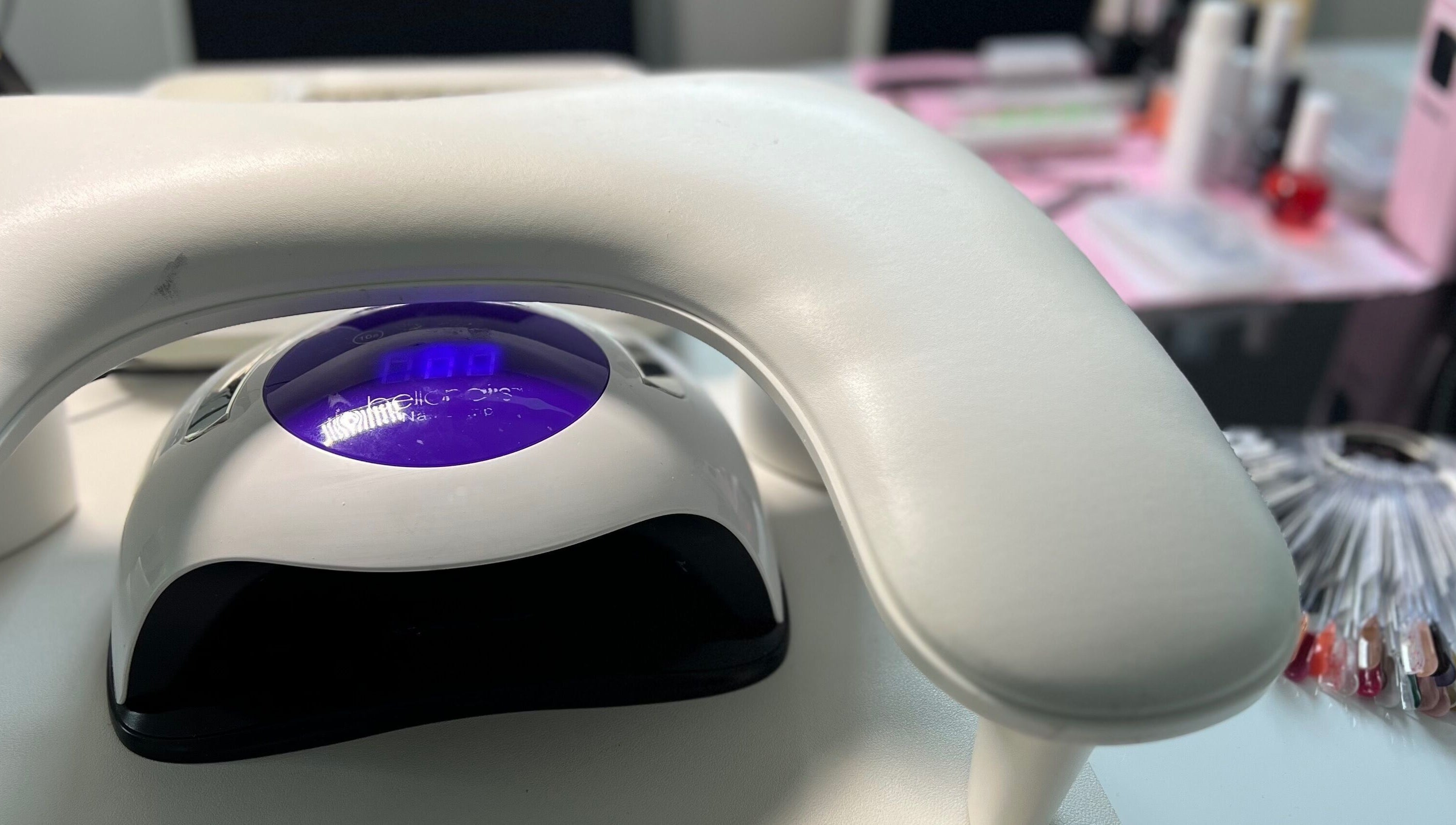 Professional nail station at S25 in Saint Austell, England, GB with LED lamp and colorful polish options.