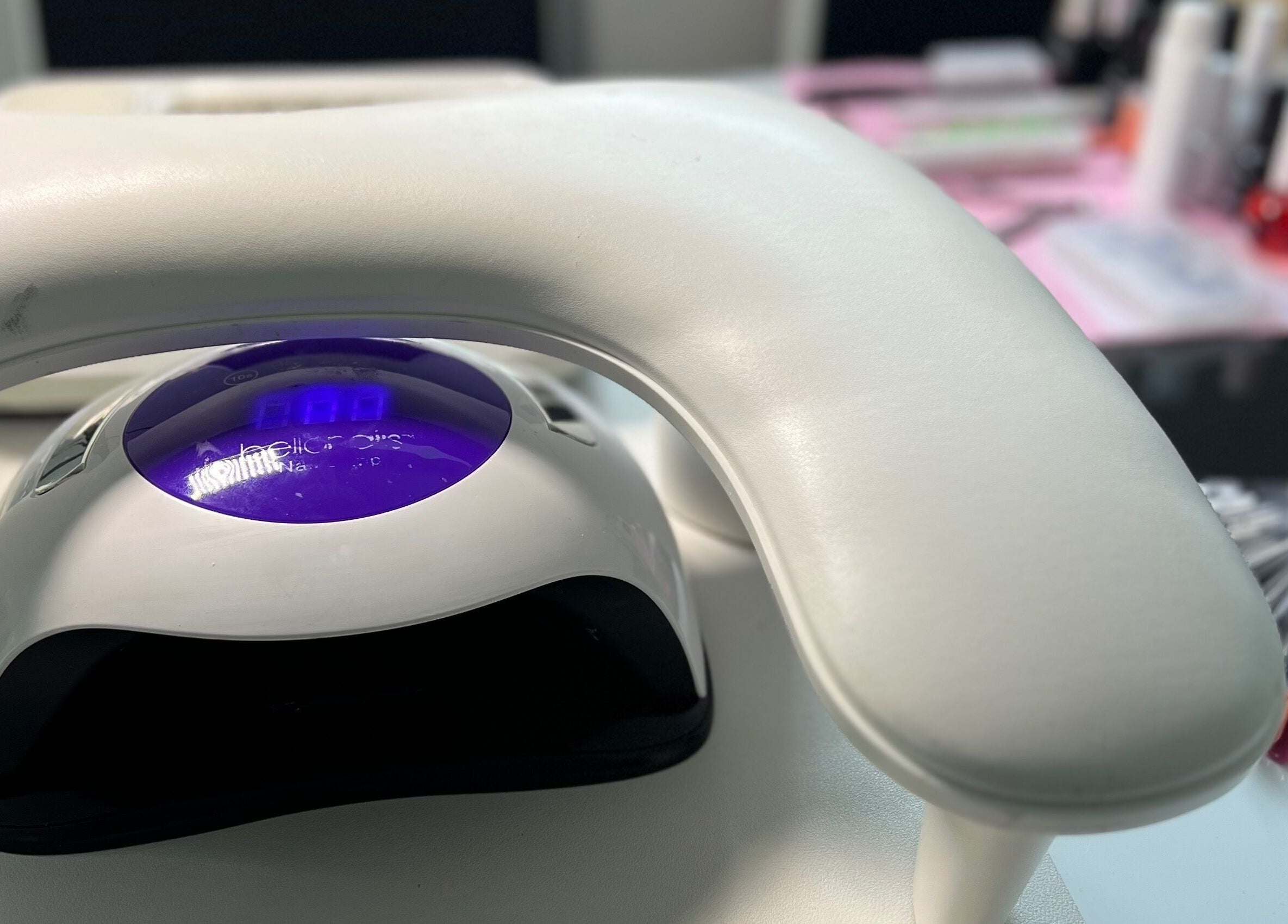 Professional nail station at S25 in Saint Austell, England, GB with LED lamp and colorful polish options.