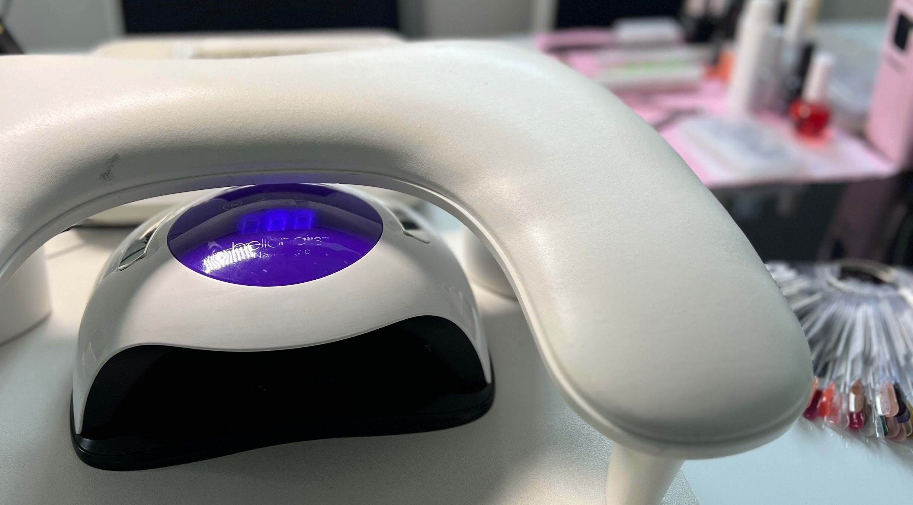 Professional nail station at S25 in Saint Austell, England, GB with LED lamp and colorful polish options.