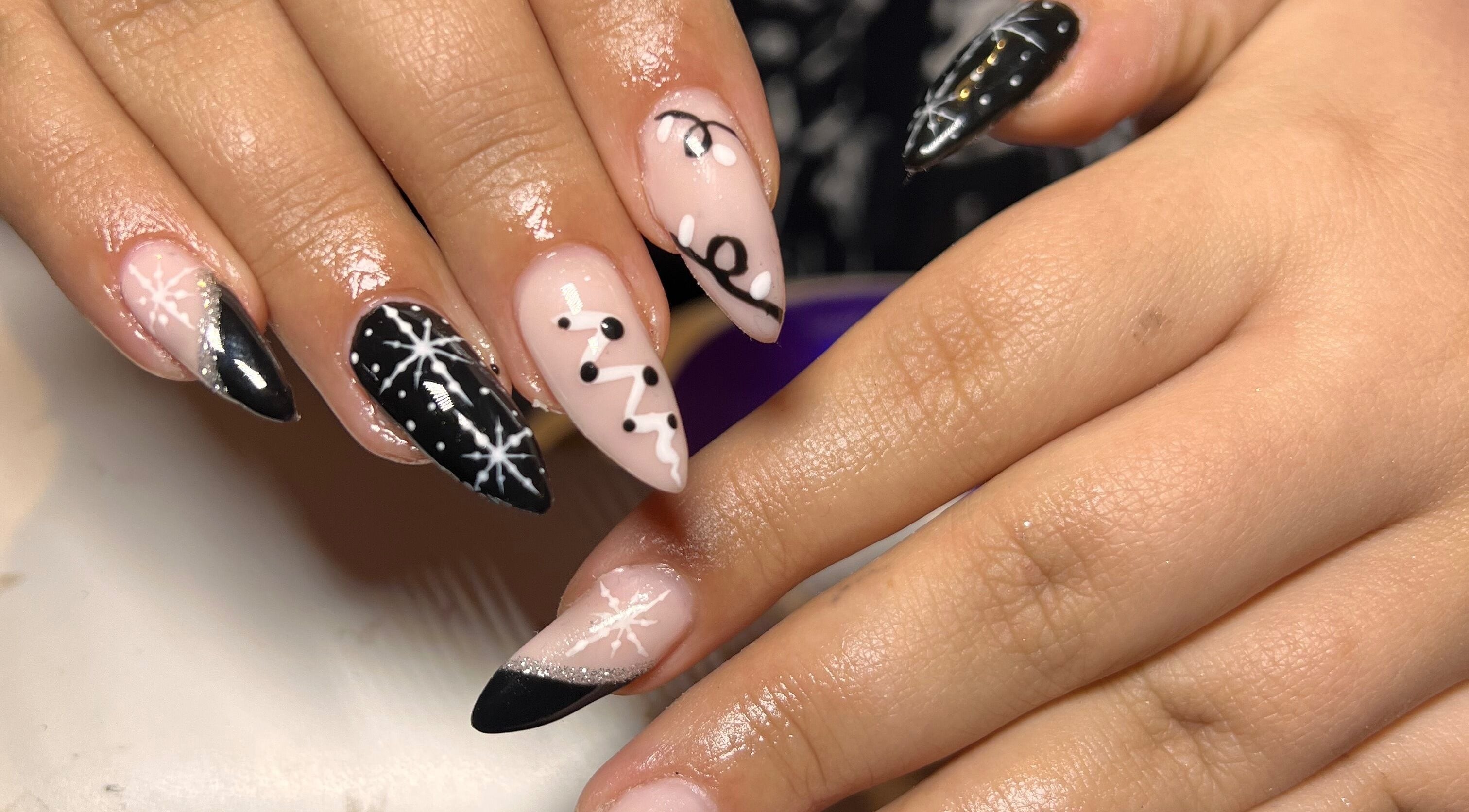 Stylish black and pink snowflake nail art at S25 in Saint Austell, England, GB.