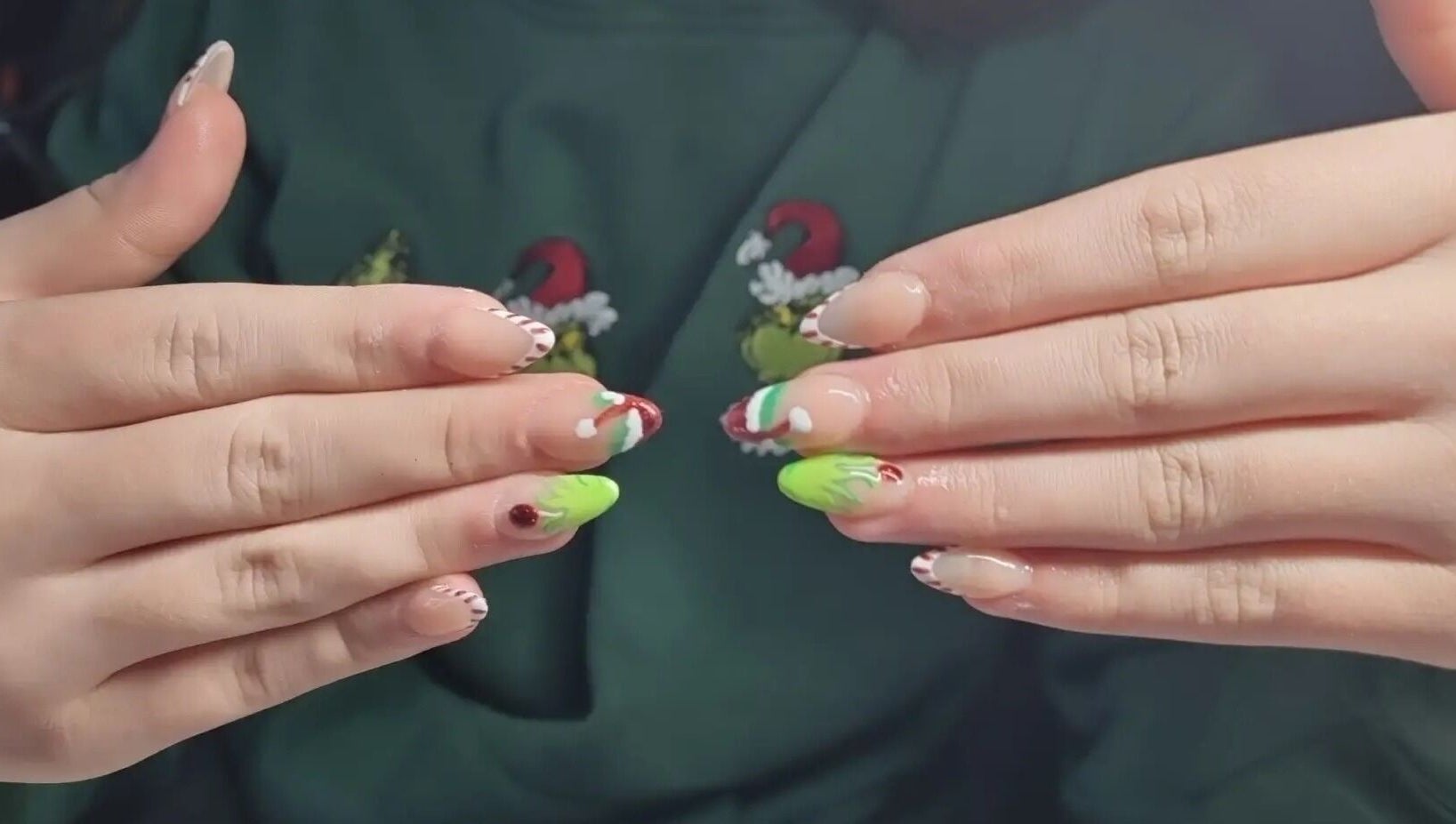 Vibrant holiday-themed nail art at Nails by Stacey in Bilston, England, GB, featuring red and green designs.