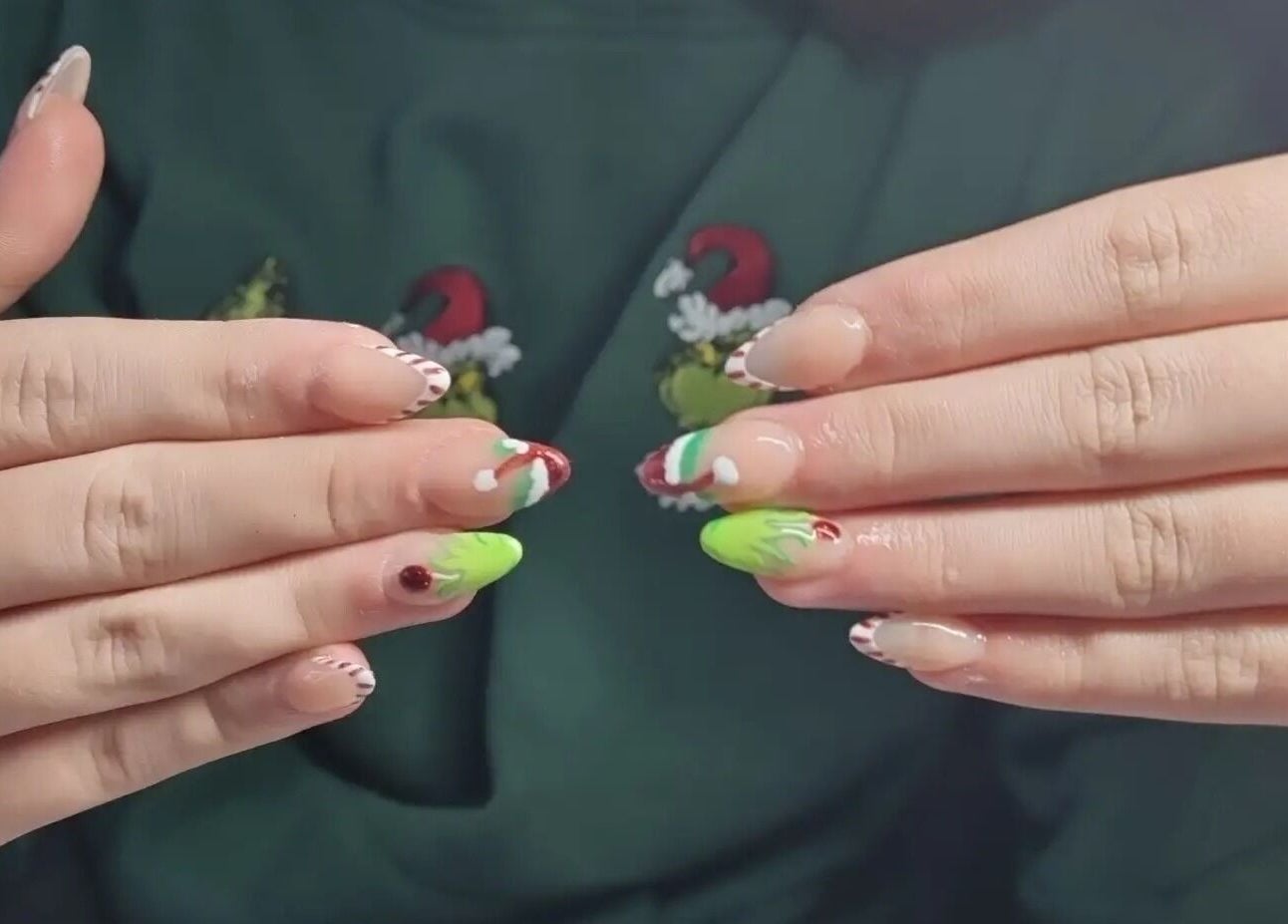 Vibrant holiday-themed nail art at Nails by Stacey in Bilston, England, GB, featuring red and green designs.