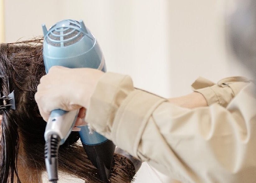 A hairstylist drying hair at Beauty Art. Studio in Tijuana, Baja California, MX.