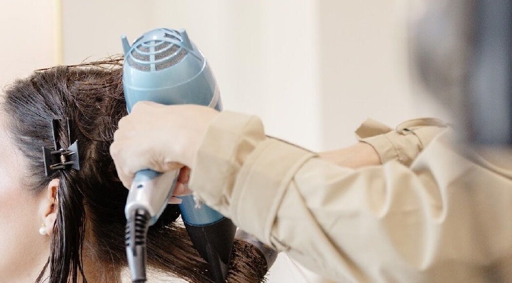 A hairstylist drying hair at Beauty Art. Studio in Tijuana, Baja California, MX.