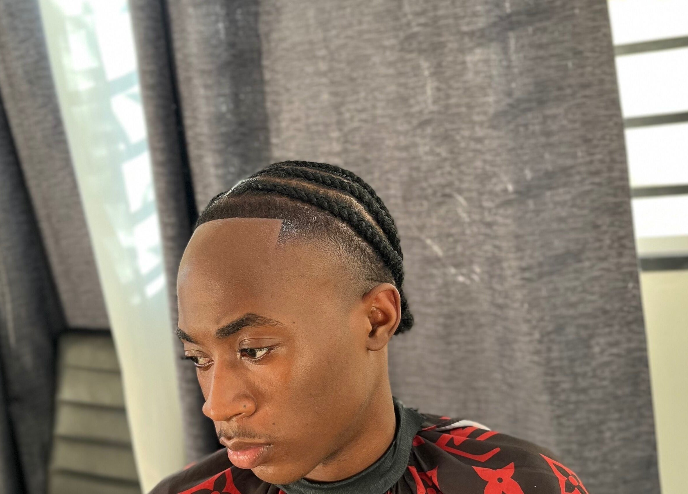 Braided hairstyle at JAYHUNCHO the barber in Paramaribo, Paramaribo, SR, showcasing modern grooming.