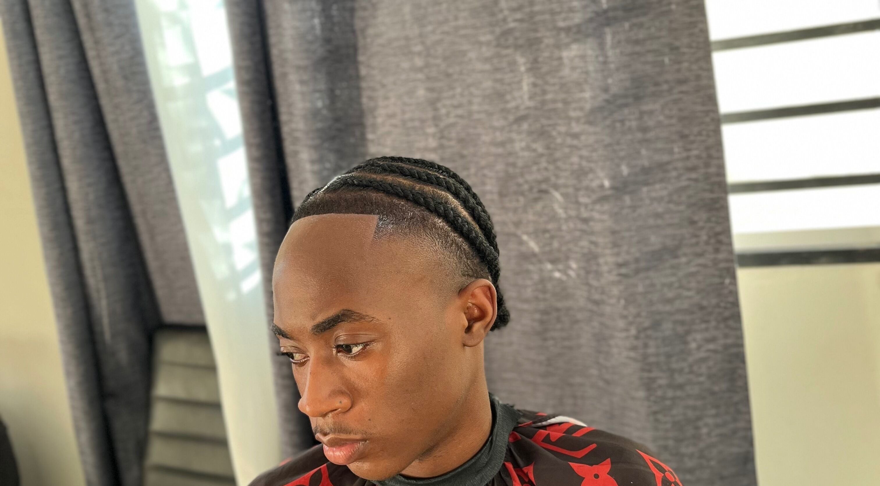 Braided hairstyle at JAYHUNCHO the barber in Paramaribo, Paramaribo, SR, showcasing modern grooming.