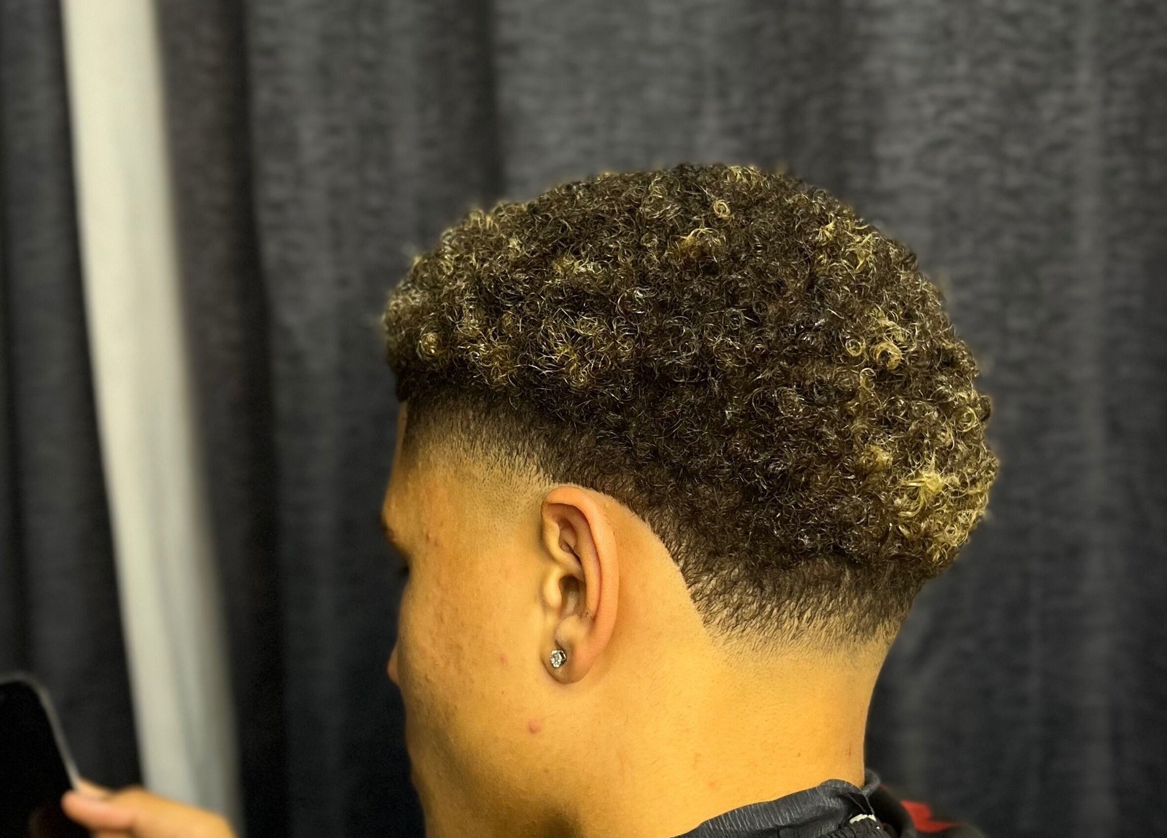 Close-up of stylish curly fade haircut at JAYHUNCHO the barber, Paramaribo, Paramaribo, SR.