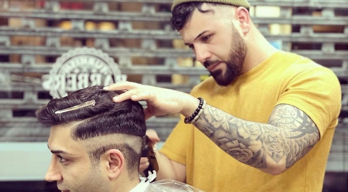 Barber crafting a precision haircut at Rusty Scissors Barber, London, England, GB.