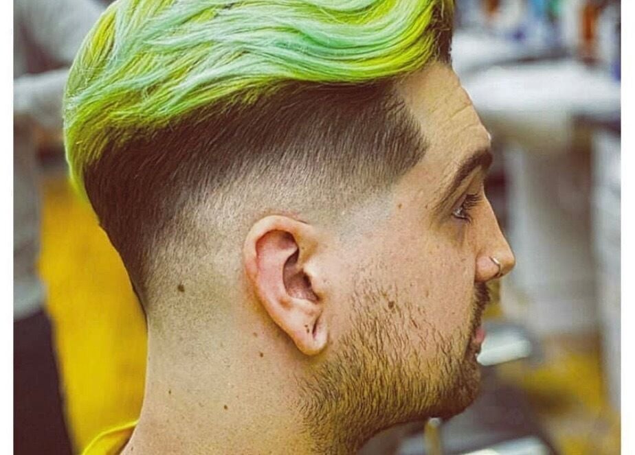 Trendy neon green hairstyle at Rusty Scissors Barber in London, England, GB, showcasing expert fade technique.