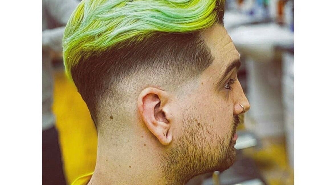 Trendy neon green hairstyle at Rusty Scissors Barber in London, England, GB, showcasing expert fade technique.