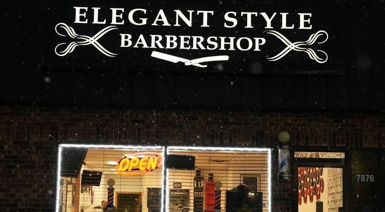 Night view of Elegant Style Barbershop in Fridley, Minnesota, US, showcasing an inviting neon open sign.
