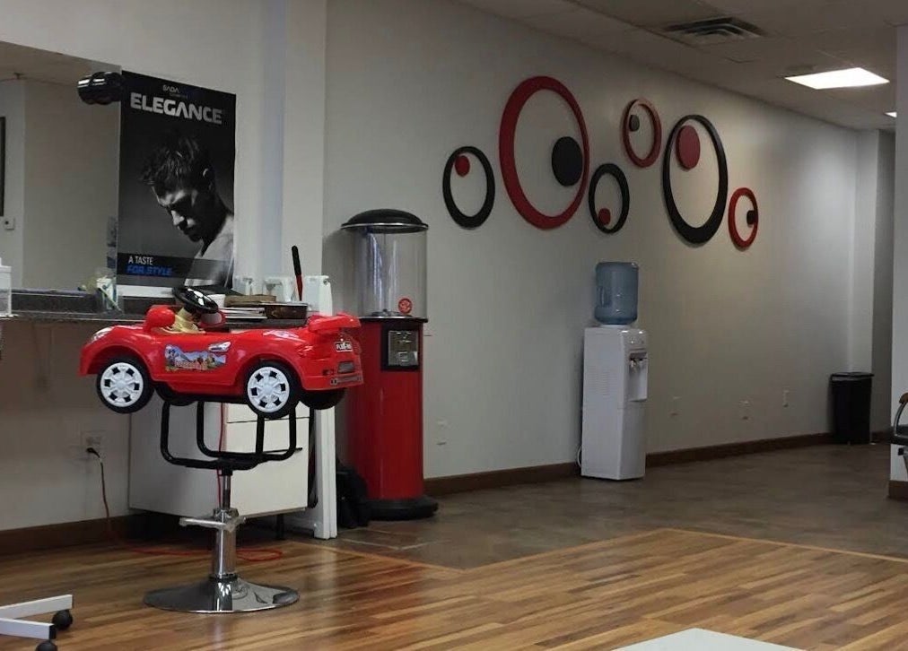 Interior of Elegant Style Barbershop, with a kids' red car chair, located in Fridley, Minnesota, US.