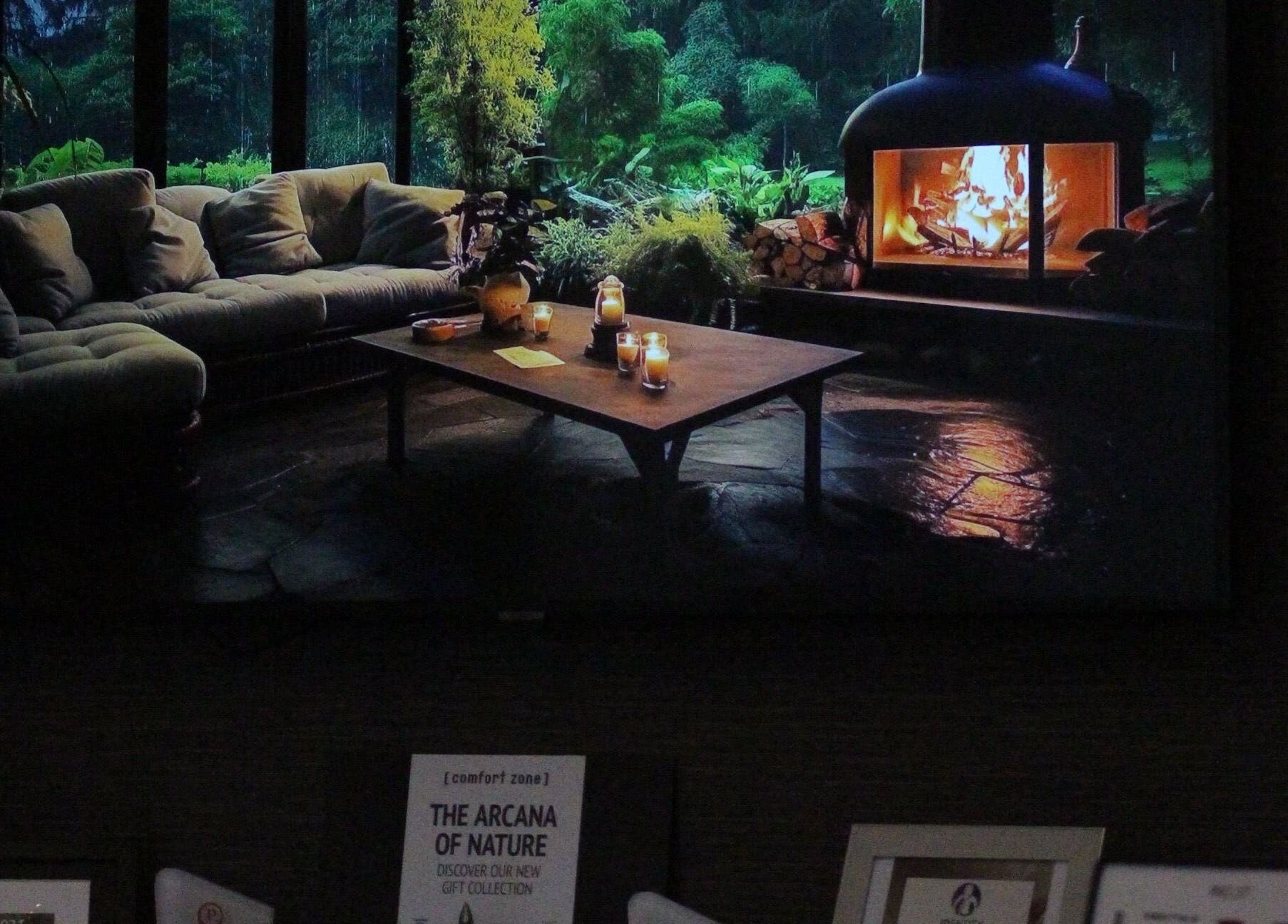 Cozy lounge with ambient lighting at Identity of Broughty Ferry, Dundee, Scotland, GB, featuring a warm fireplace.