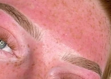 Close-up of well-groomed eyebrows with natural freckles, at By Resiân in Coventry, England, GB.