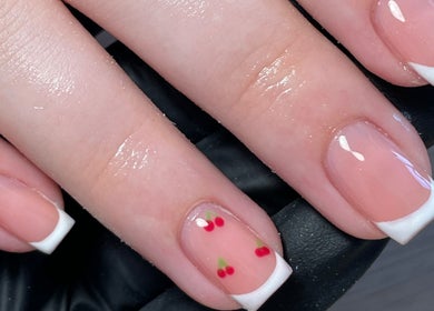 Elegant French manicure with cherry design at Maia Emily Beauty, Derby, England, GB.
