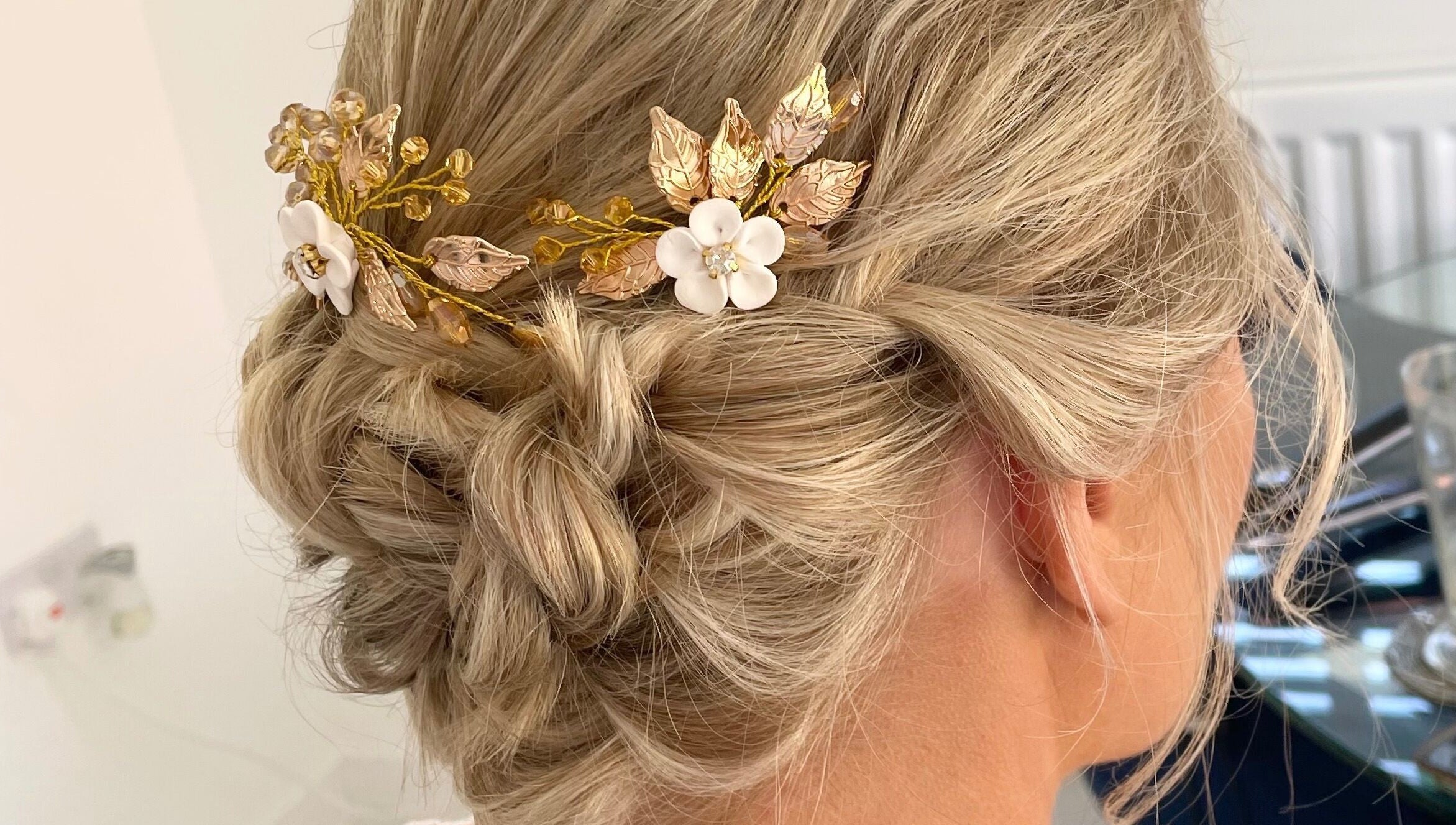 Elegant bridal updo with golden floral hairpiece at Josephine's Beauty, Thorrington, England, GB.