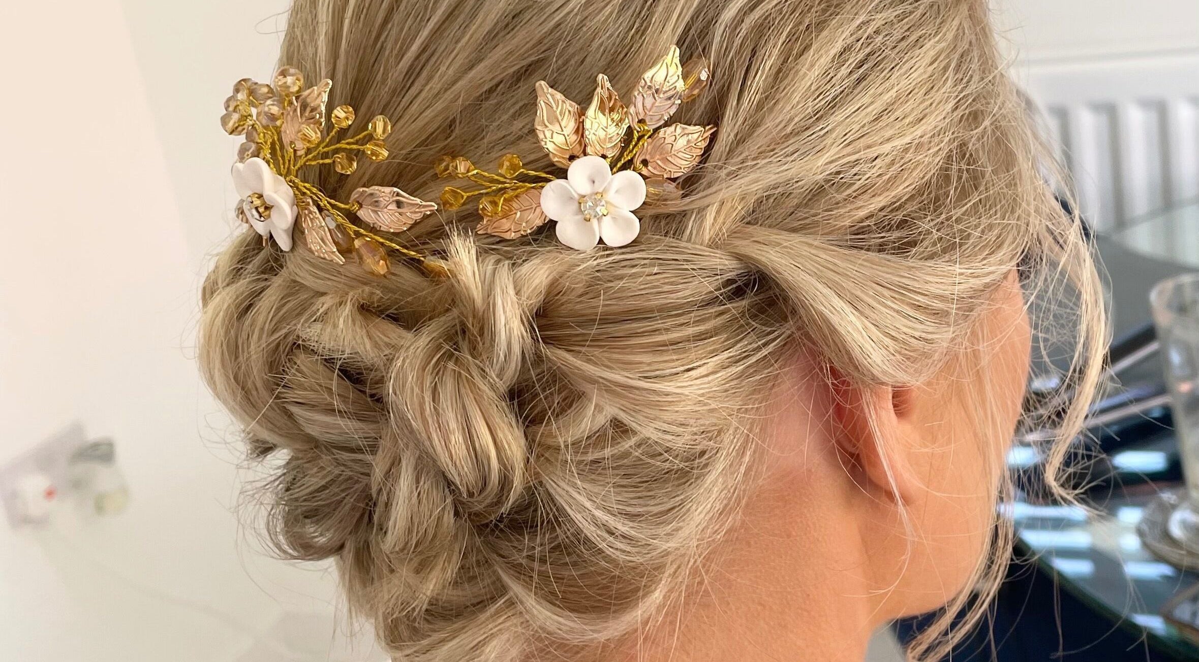 Elegant bridal updo with golden floral hairpiece at Josephine's Beauty, Thorrington, England, GB.