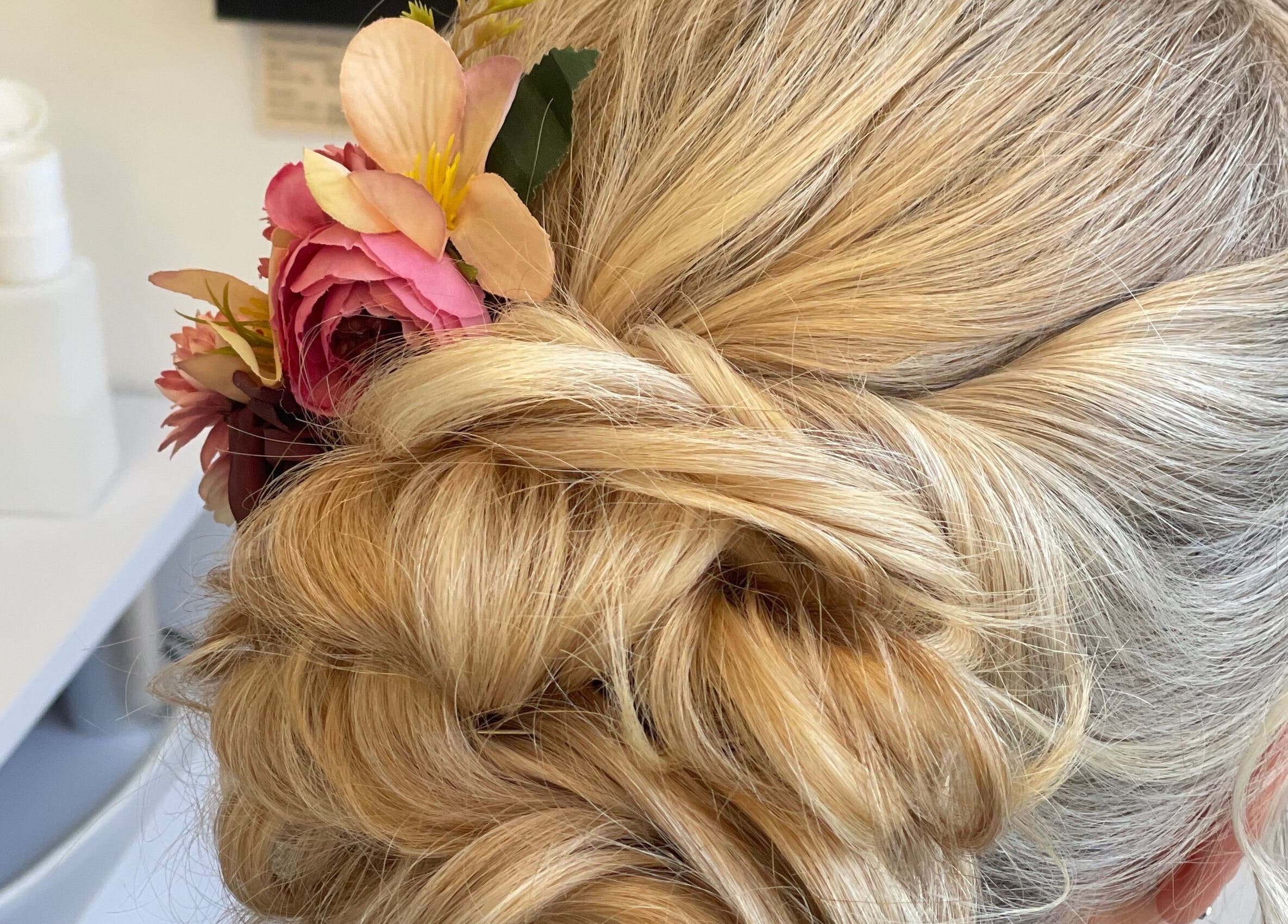 Elegant floral updo hairstyle at Josephine's Beauty in Thorrington, England, GB. A perfect choice for special occasions.
