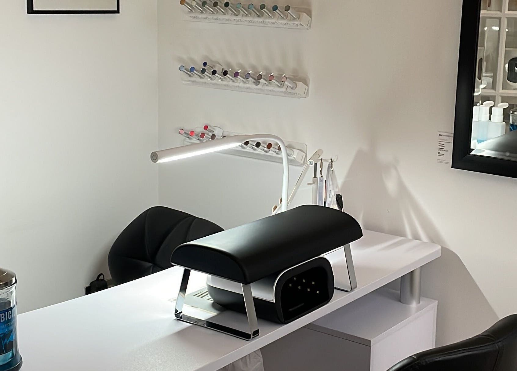 Modern nail station at Josephine's Beauty, Thorrington, England, GB. Elegant setup with nail polish display.