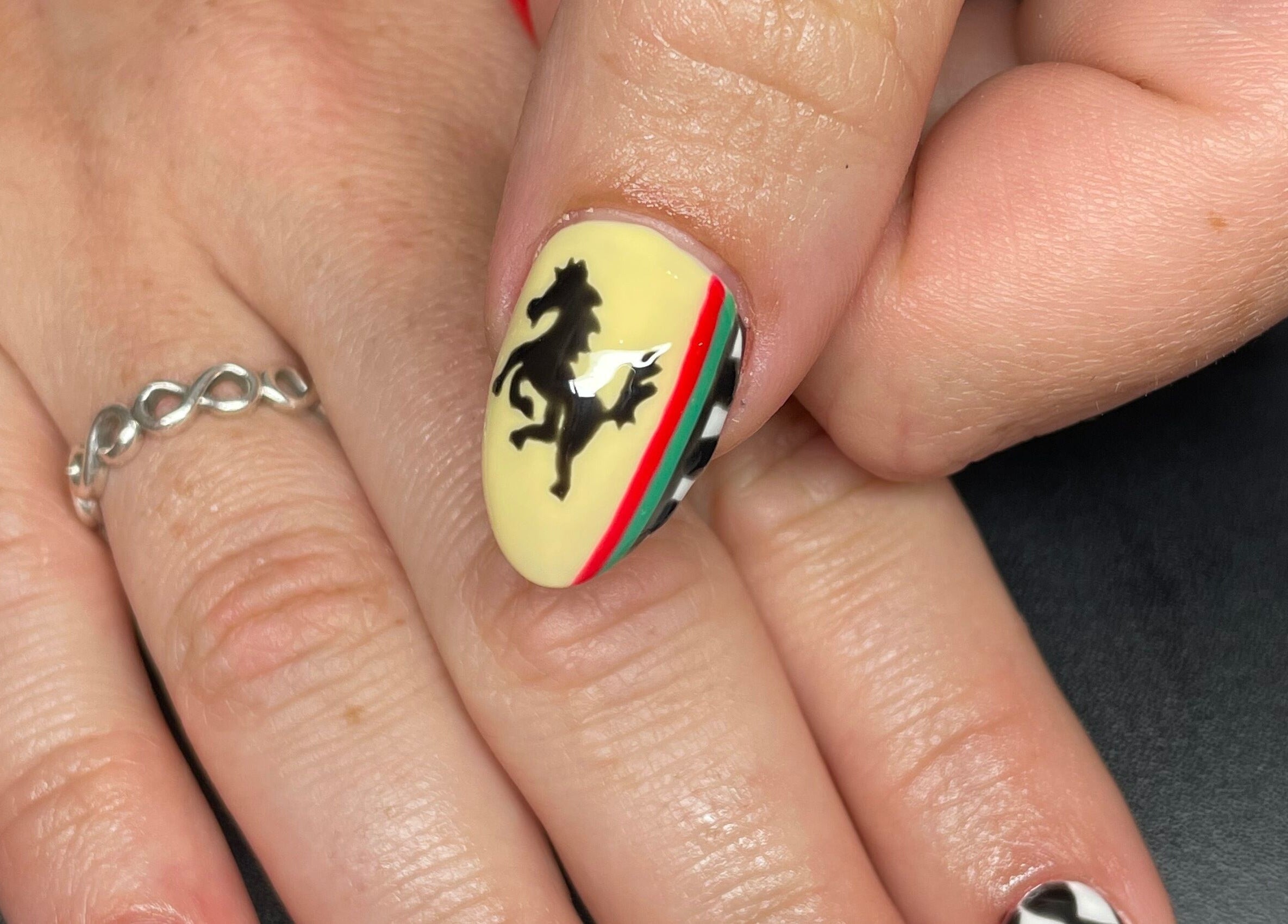 Stylish Ferrari-inspired nail design at Josephine's Beauty, Thorrington, England, GB.