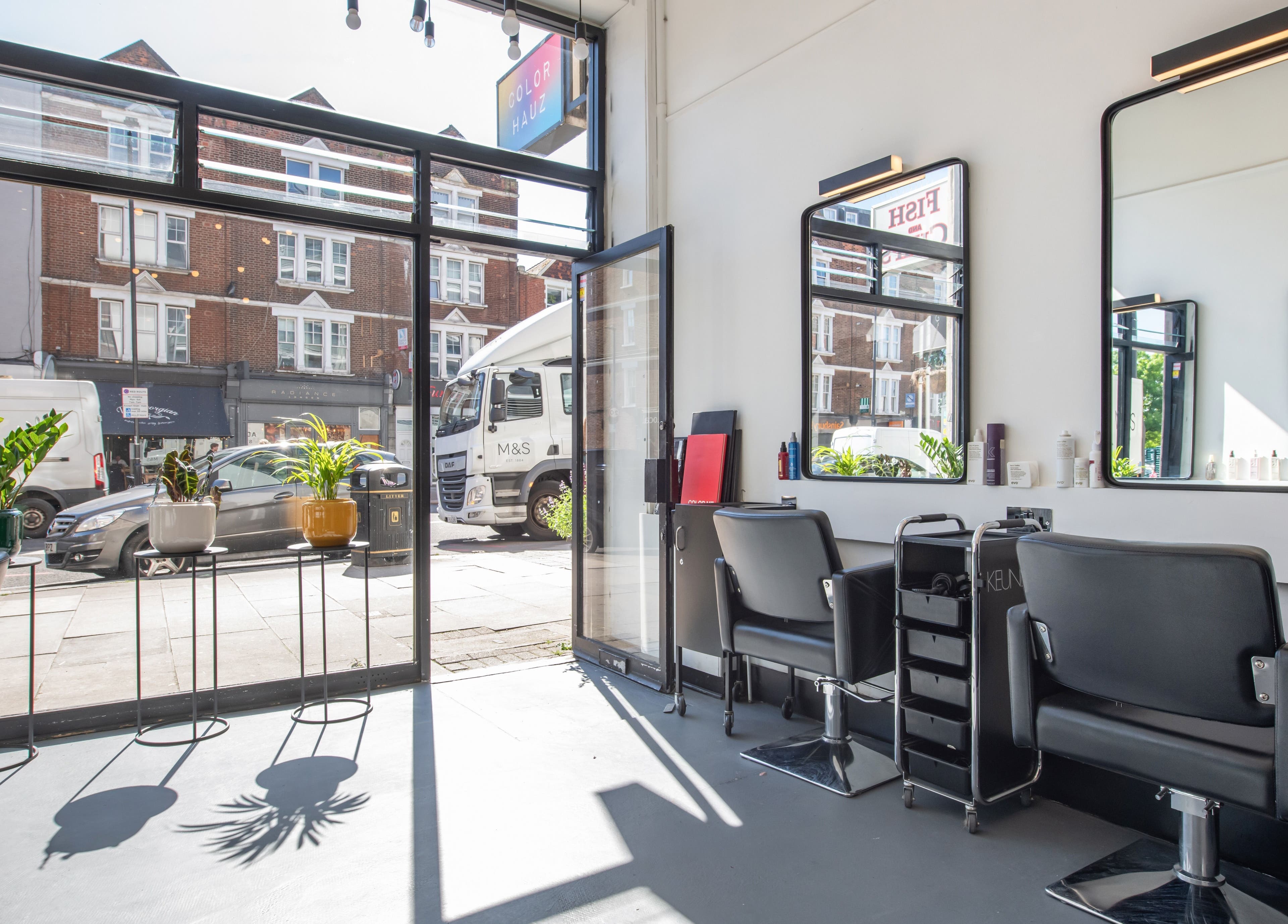 Modern salon interior at Colour Hauz, London, England, GB with stylish chairs and natural light.