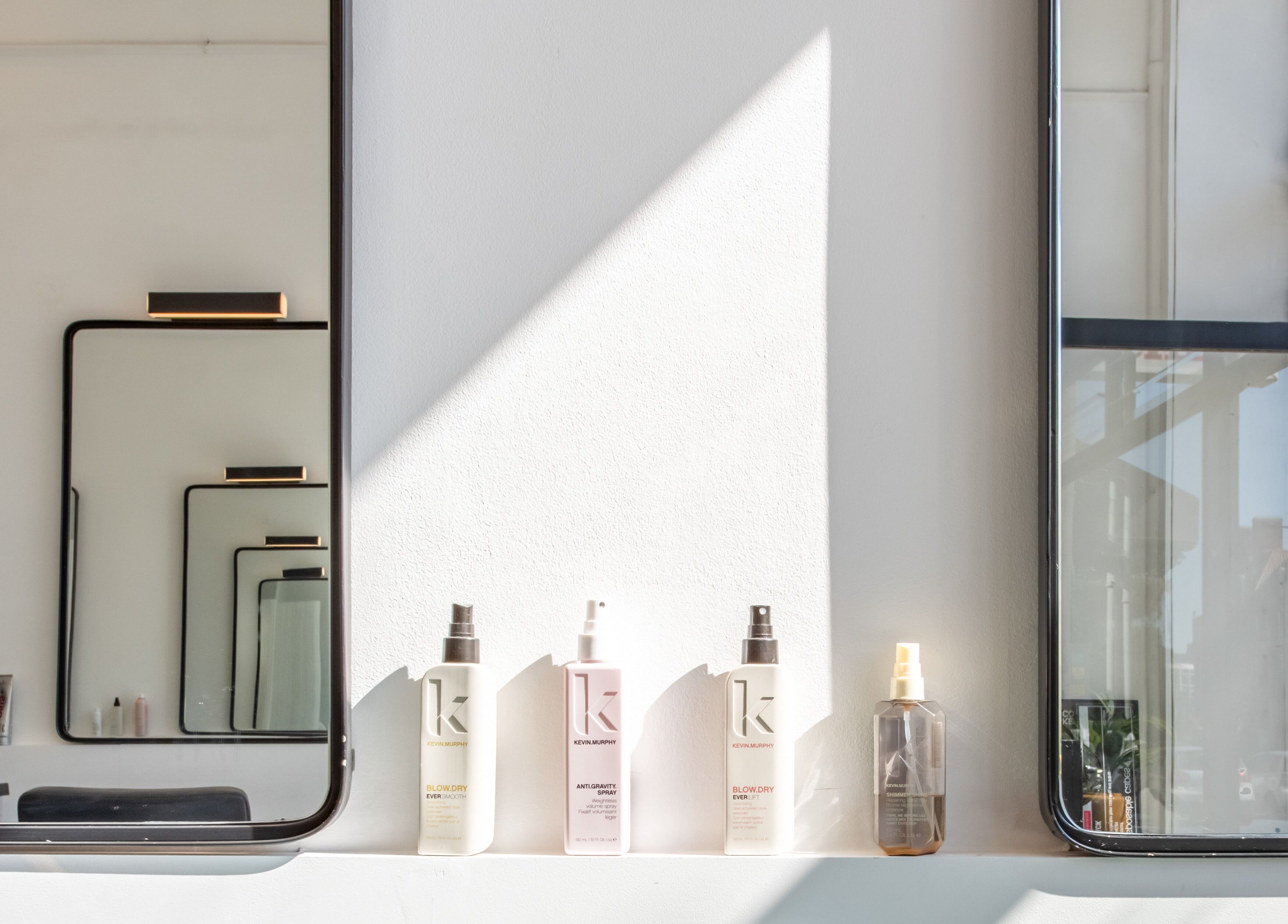 Stylish salon mirrors and products at Colour Hauz, London, England, GB, showcasing modern beauty ambiance.