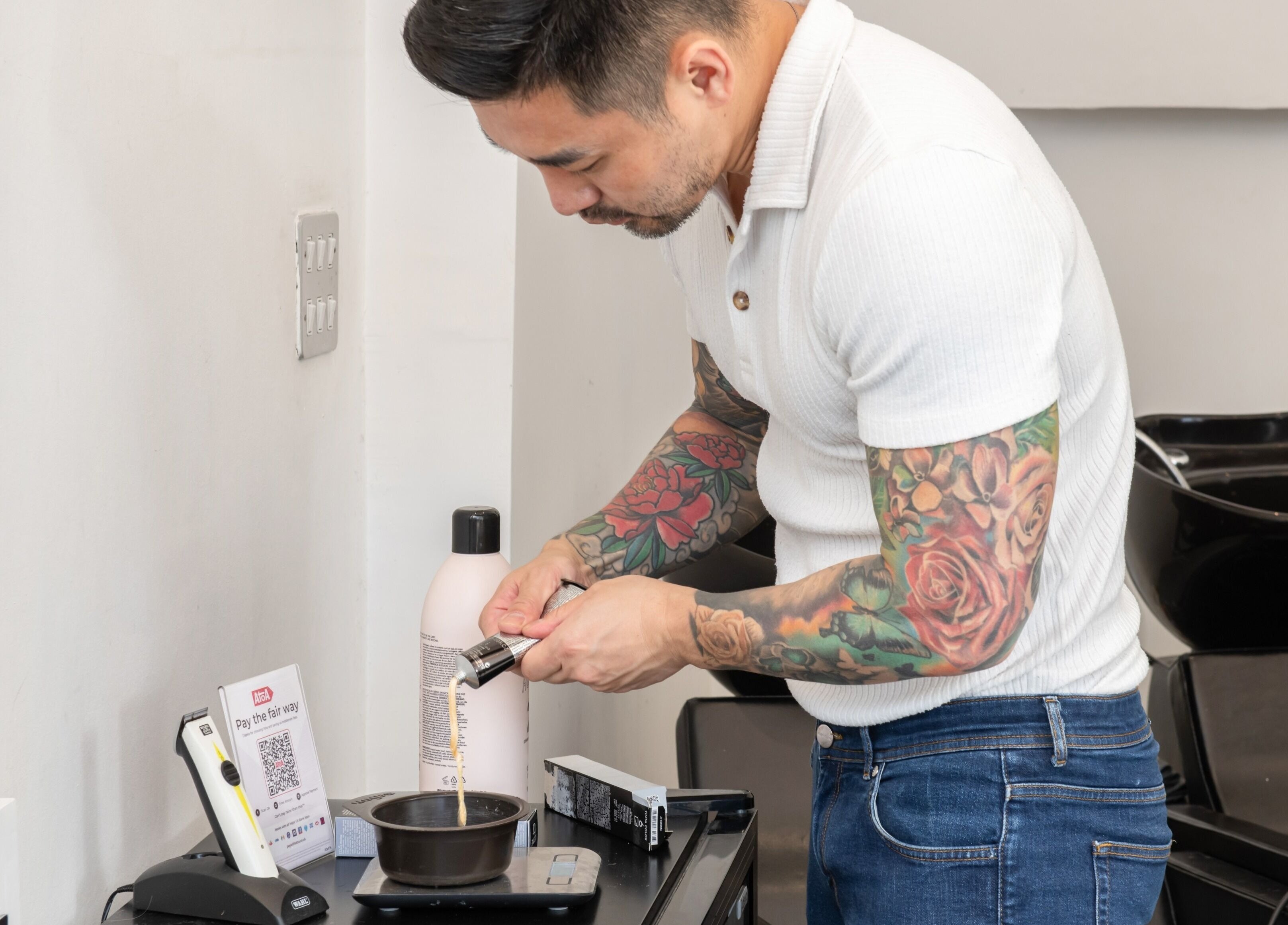 Stylist at Colour Hauz in London, England, GB preparing hair dye with precision.