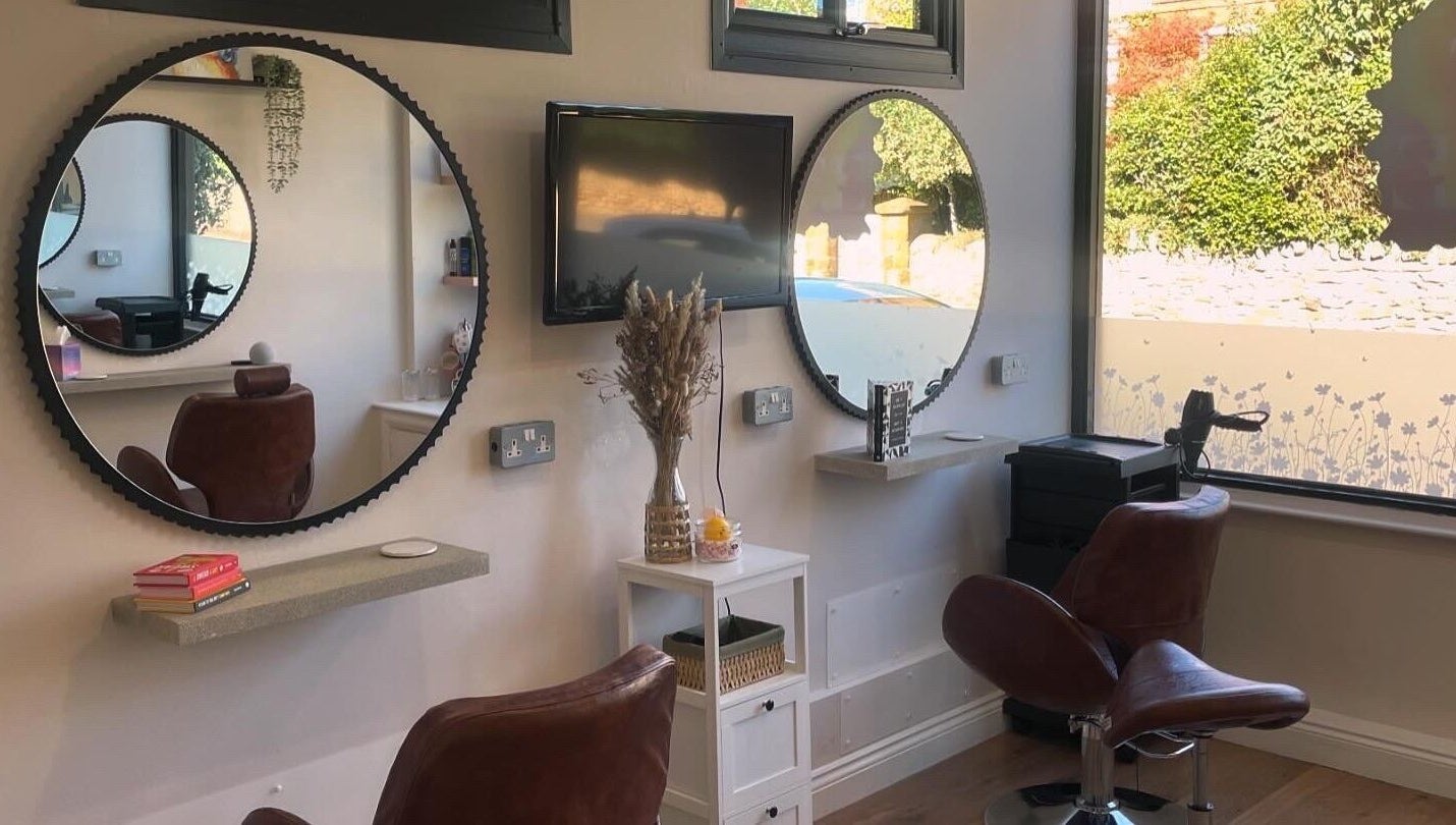 Elegant salon chairs and mirrors at Just Grace Hairdressing, Northampton, England, GB, showcasing modern decor.