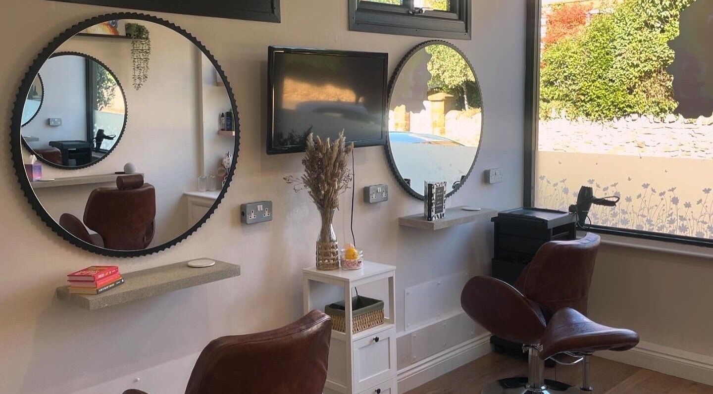 Elegant salon chairs and mirrors at Just Grace Hairdressing, Northampton, England, GB, showcasing modern decor.