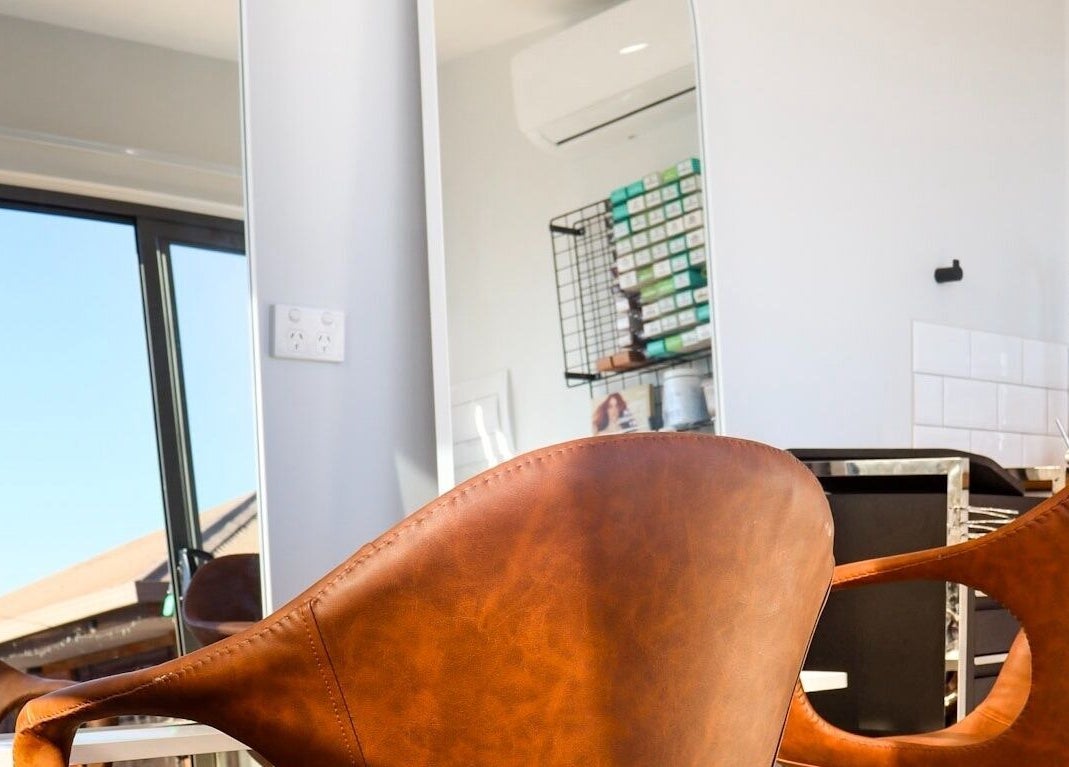 Modern styling area at Smart Hair Studio in Terang, Victoria, AU with sleek chairs and large mirrors.