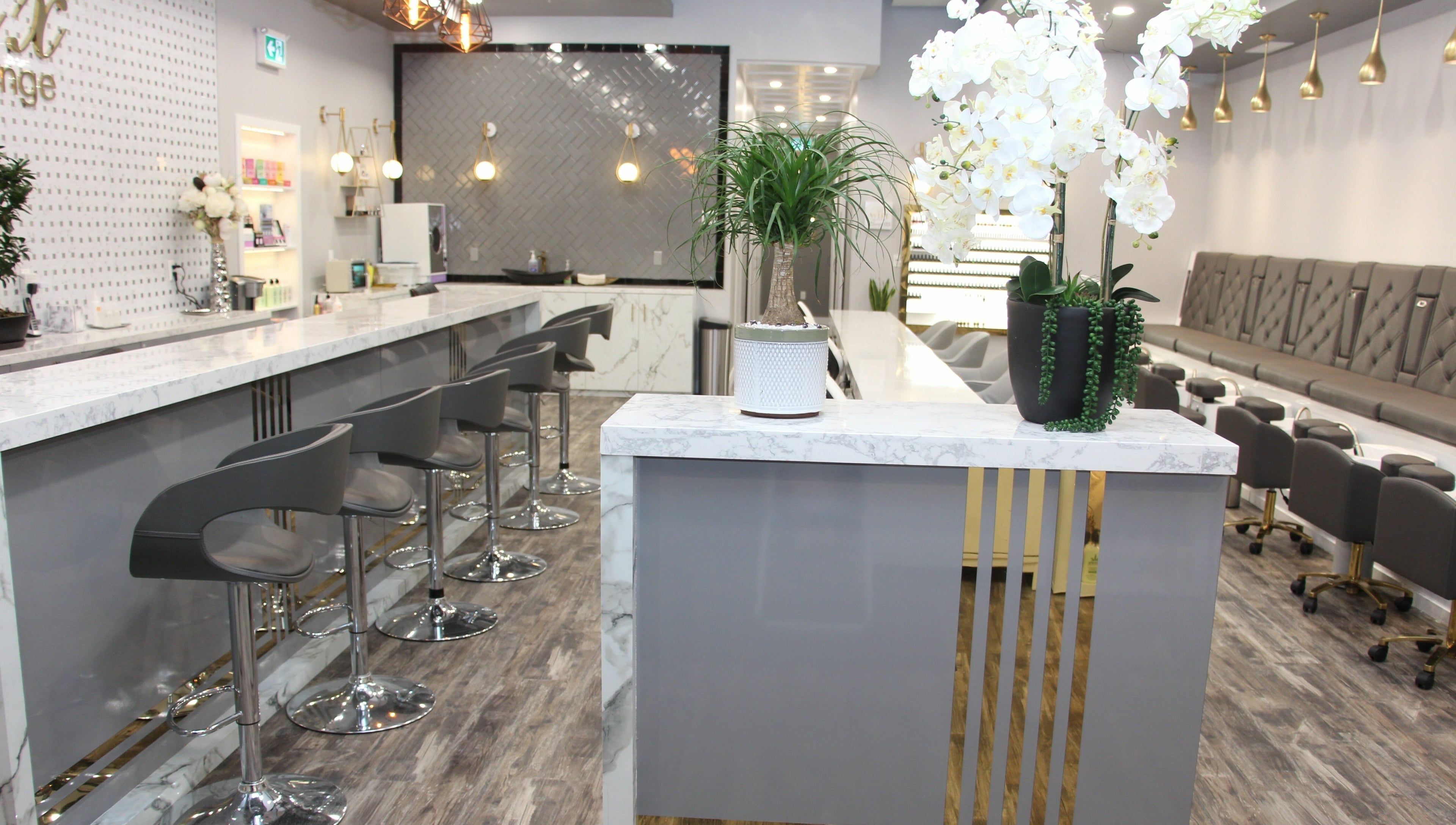 Sophisticated interior of MLux Spa & Nails Lounge in Red Deer, Alberta, CA with modern décor and seating.