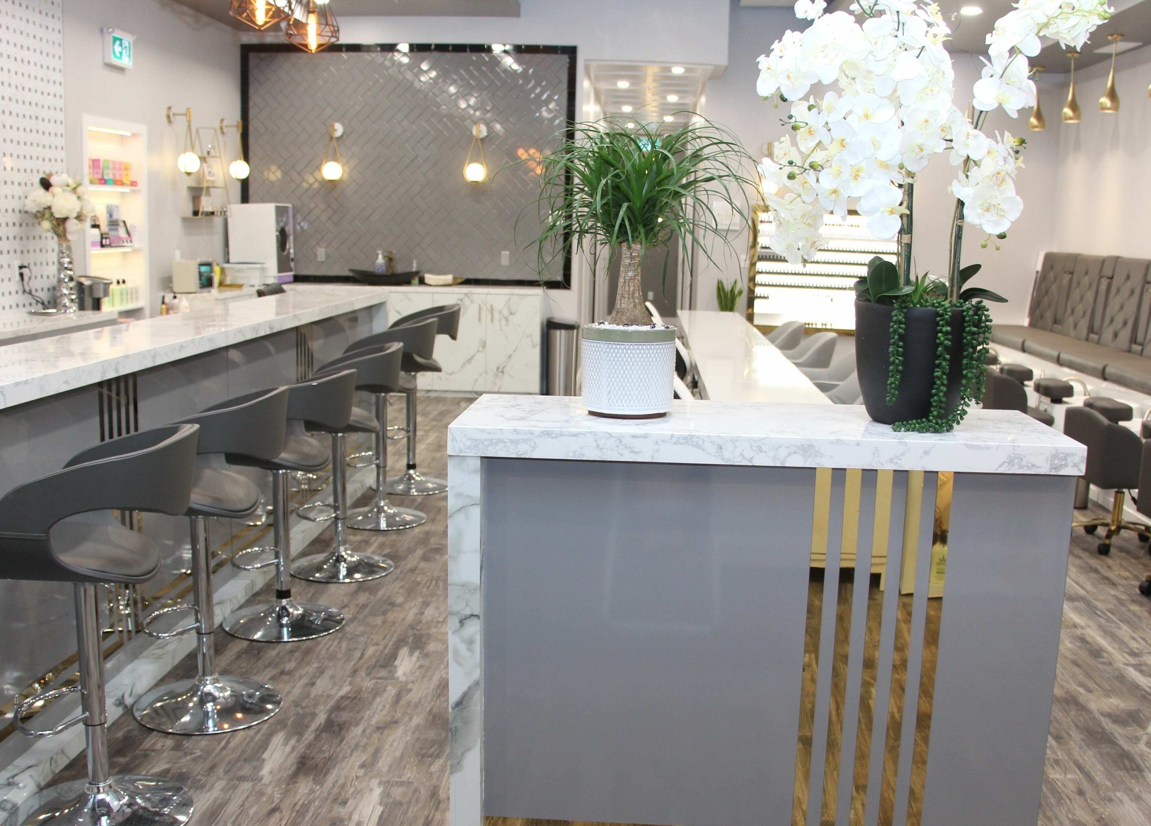 Sophisticated interior of MLux Spa & Nails Lounge in Red Deer, Alberta, CA with modern décor and seating.
