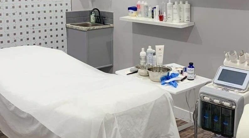 Luxurious spa room at MLux Spa & Nails Lounge in Red Deer, Alberta, CA featuring a treatment bed and equipment.