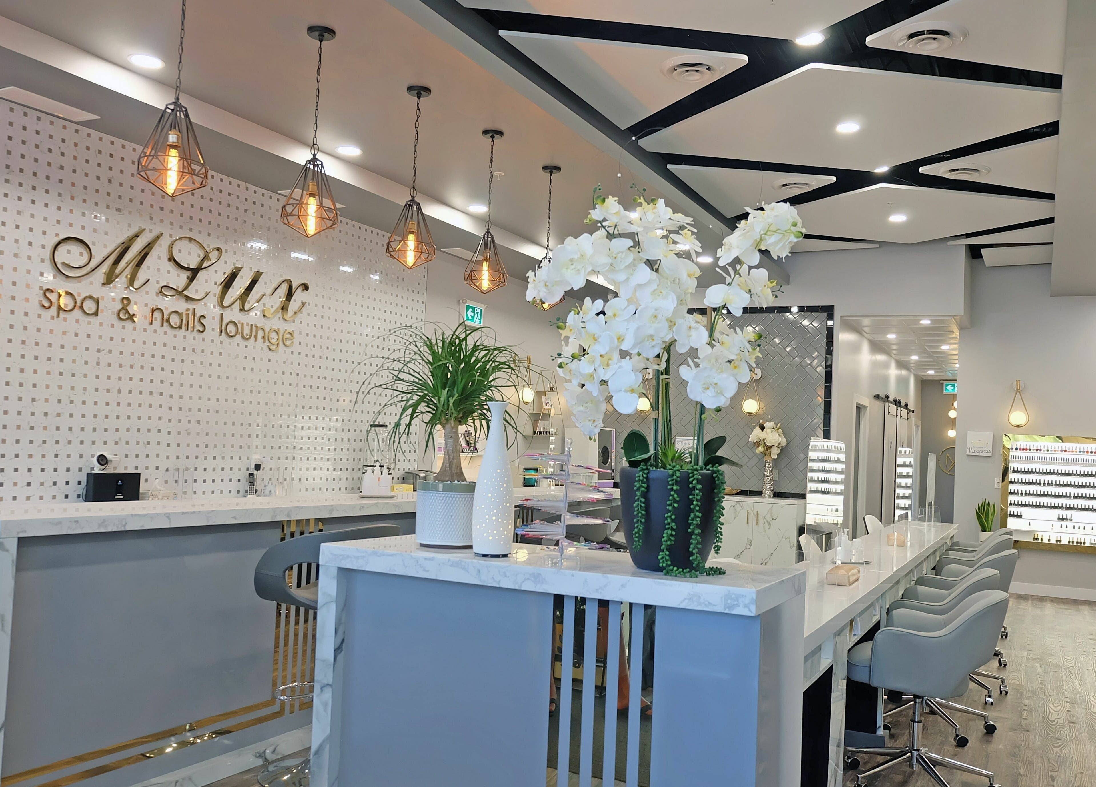Modern interior of MLux Spa & Nails Lounge, Red Deer, Alberta, CA, featuring stylish decor and chic lighting.