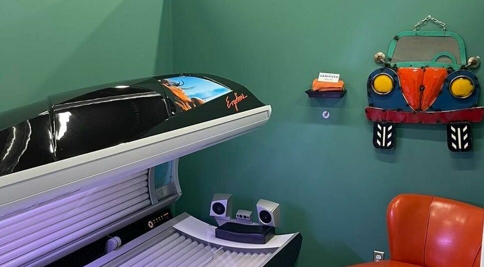 Tanning bed in Industry Salon and Tanning, Chatham-Kent, Ontario, CA, with vibrant decor and comfortable seating.