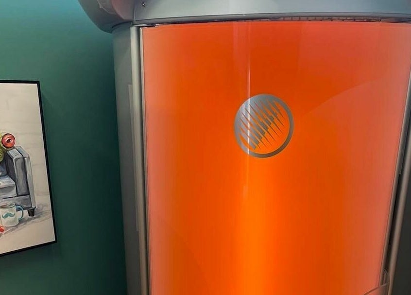 Vibrant tanning booth at Industry Salon and Tanning in Chatham-Kent, Ontario, CA with modern decor.