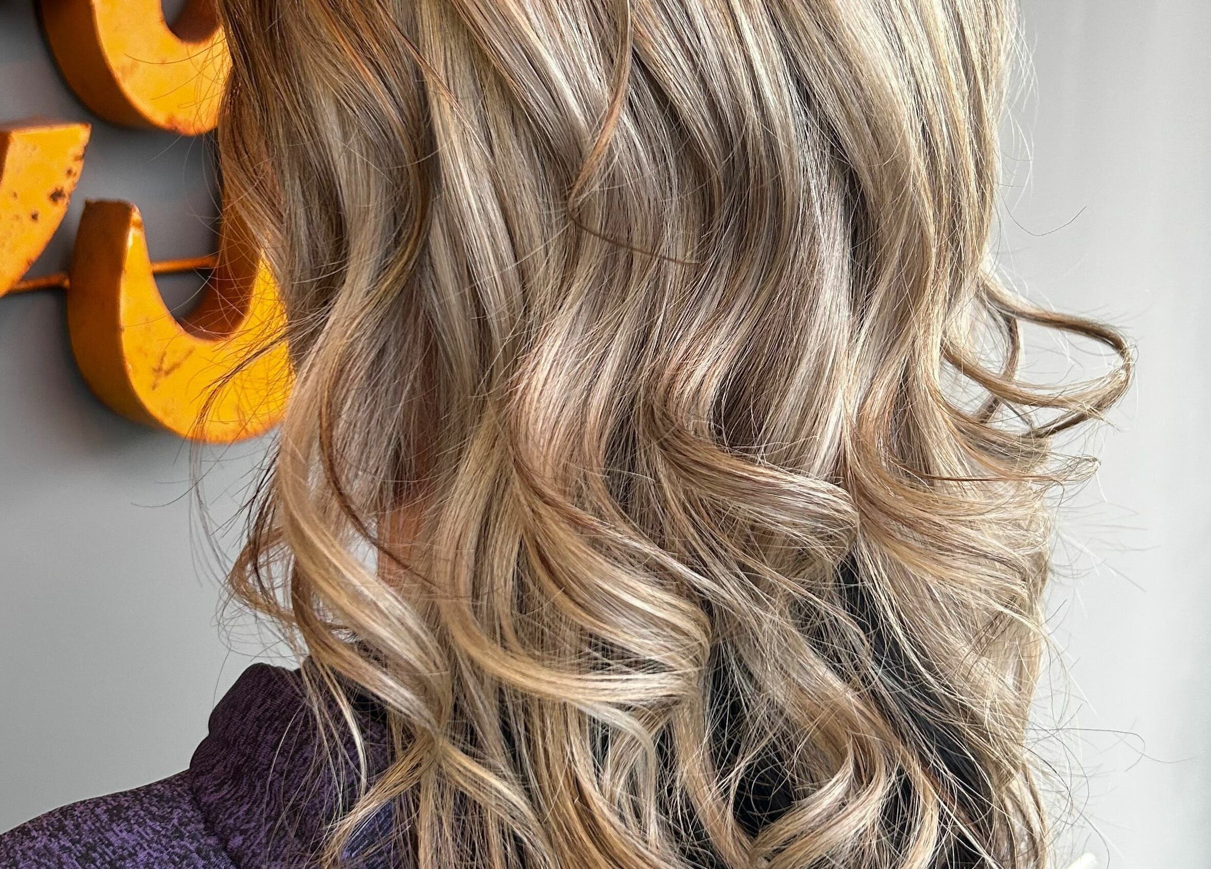 Blonde wavy hairstyle at Industry Salon and Tanning, Chatham-Kent, Ontario, CA.