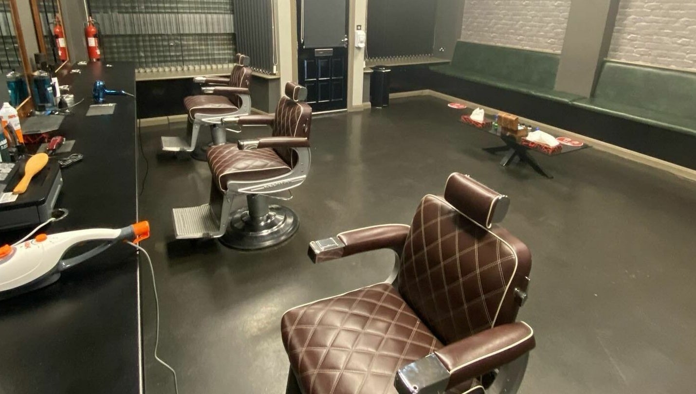 Chic interior of Paul Dawson's Barbers in Stockton-on-Tees, England, featuring stylish barber chairs.