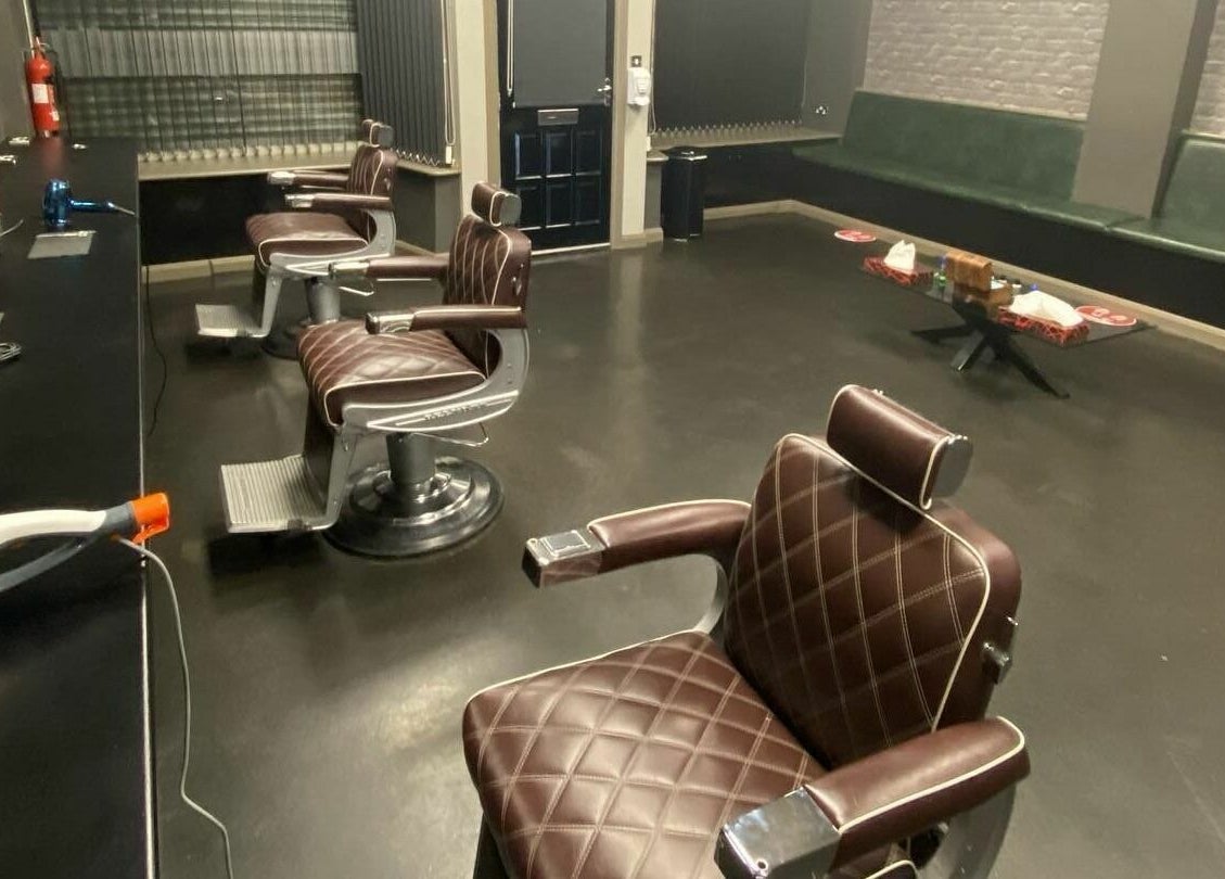 Chic interior of Paul Dawson's Barbers in Stockton-on-Tees, England, featuring stylish barber chairs.