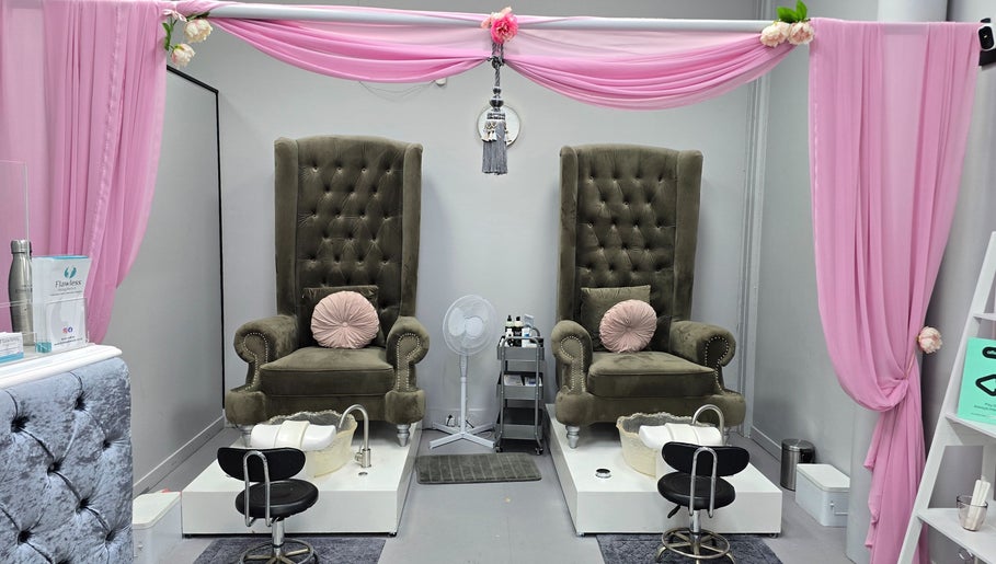 Elegant pedicure chairs at Flawless Face and Beauty Wellington, Wellington, NZ, surrounded by soft pink drapery.