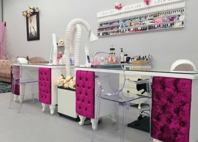 Elegant nail station at Flawless Face and Beauty Wellington, Wellington, NZ with plush seating and nail polish display.