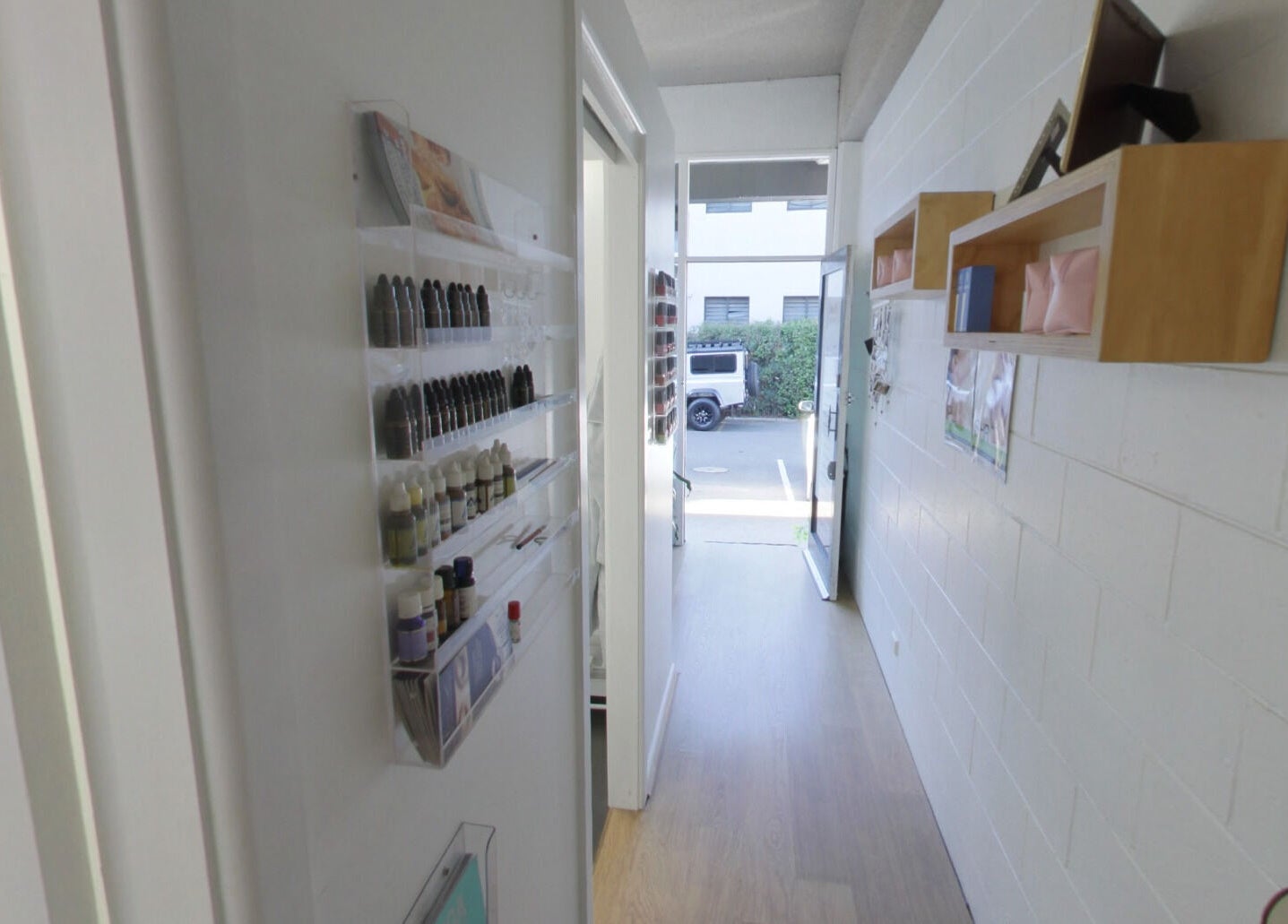 Chic hallway at Venus Artistry Brow and Lash Studio, Sydney, New South Wales, AU, with tidy shelves and an open door.